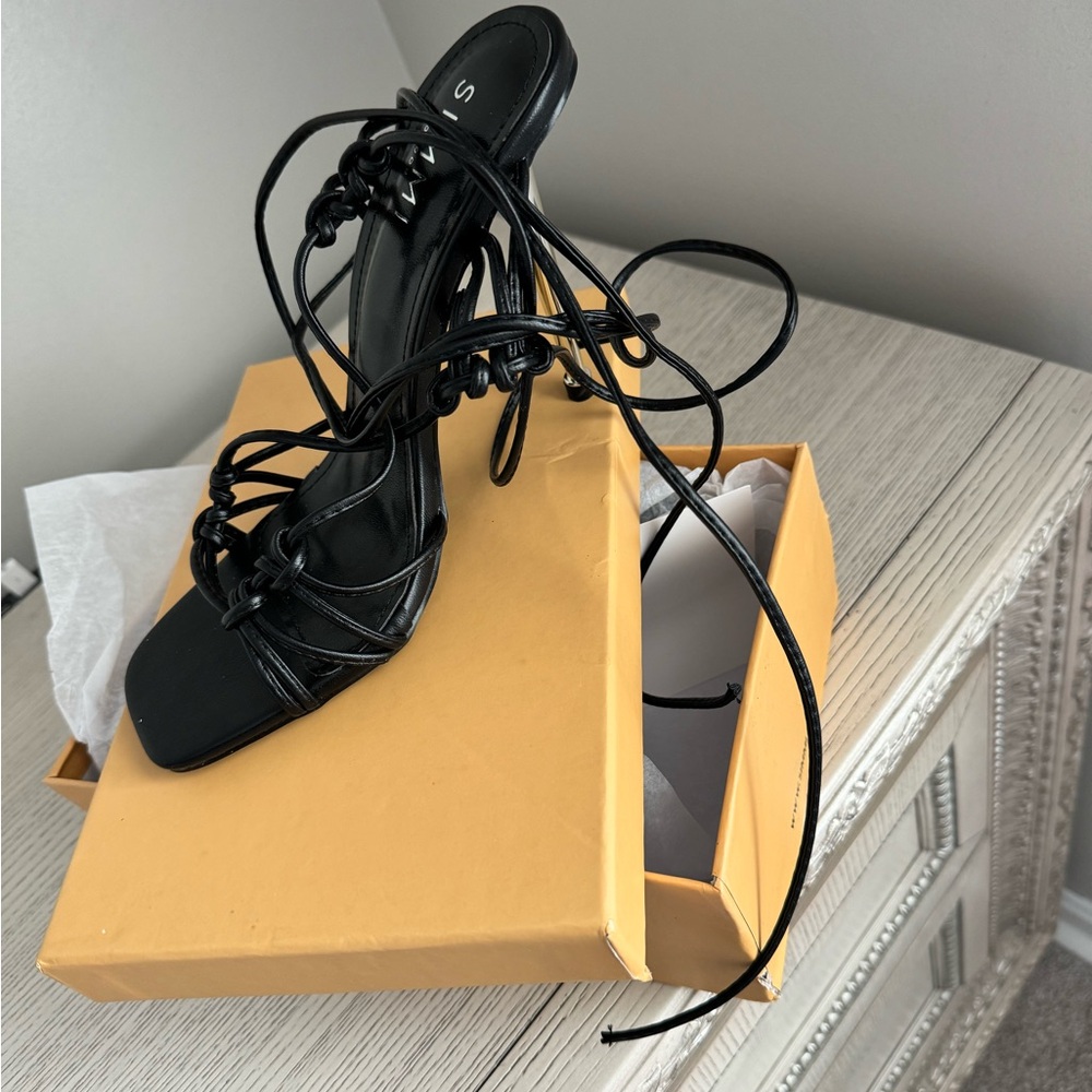 Women’s black high heels with tie up strings. Never worn size US 9
